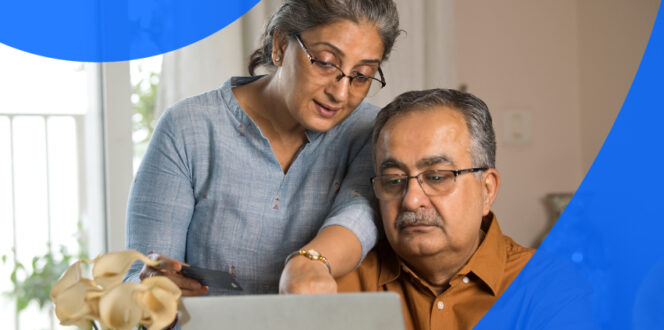 An elderly couple reviewing EMR vs EHR in Canada on their laptop.