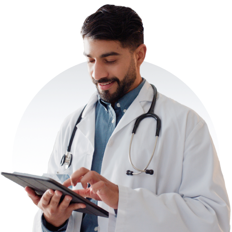 Physician smiles in front of a maple leaf background while looking down at their tablet.